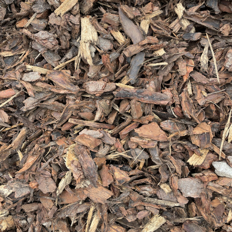 A pile of light-coloured pine bark mulch chips